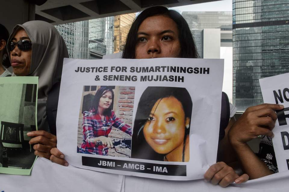 A migrant worker holds up a piece of pap