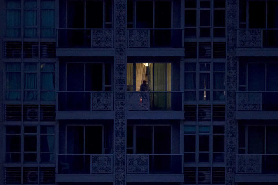 A policeman checks the crime scene at the British banker Rurik Jutting's residential flat where Indonesian women bodies were found dead in Hong Kong's Wan chai district