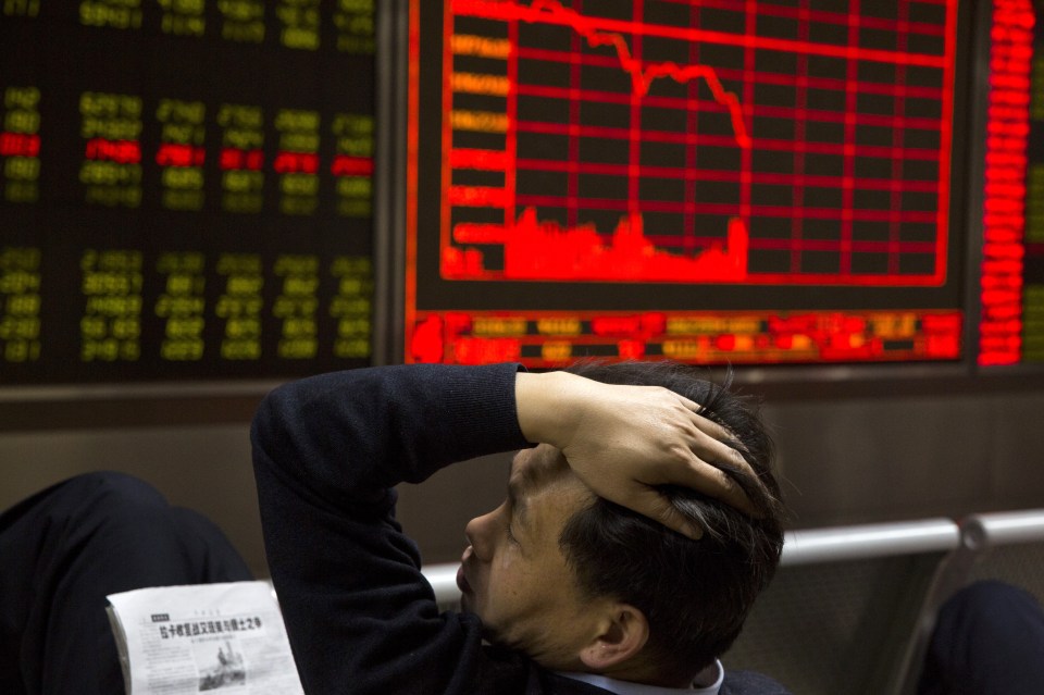Turmoil... A Chinese man reacts near a board showing the Shanghai Stock Exchange