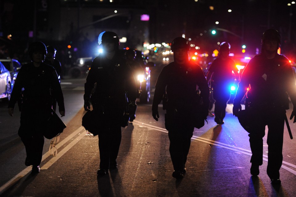 Cops patrol after several dozen protesters gathered in downtown Oakland to protest the election of Donald Trump 
