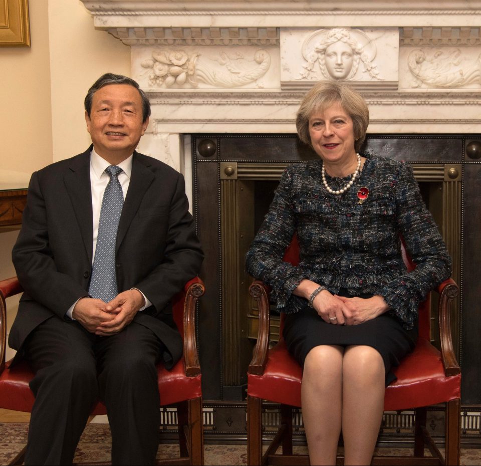 Theresa May, centre, and Chancellor of the Exchequer, Philip Hammond, greet China's Vice Premier, Ma Kai,