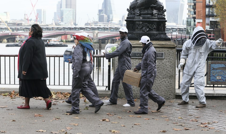 A beekeeper and other extras in overalls carrying animals in cages were part of the action on the Southbank