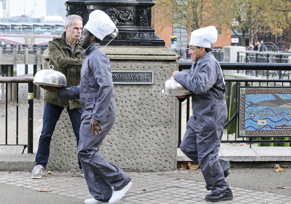 A further two members of the kitchen team run along in front of Phil