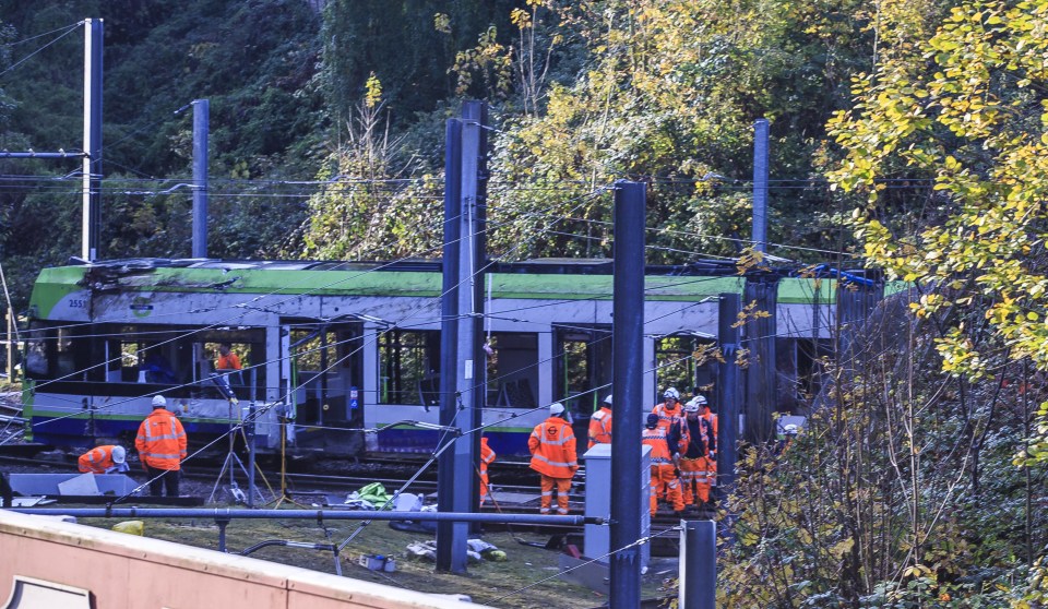 Workers were seen today trying to move the tram which crashed earlier this week