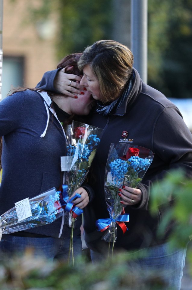 Family and friends of one of the deceased lay flowers near the scene of the tram crash, 