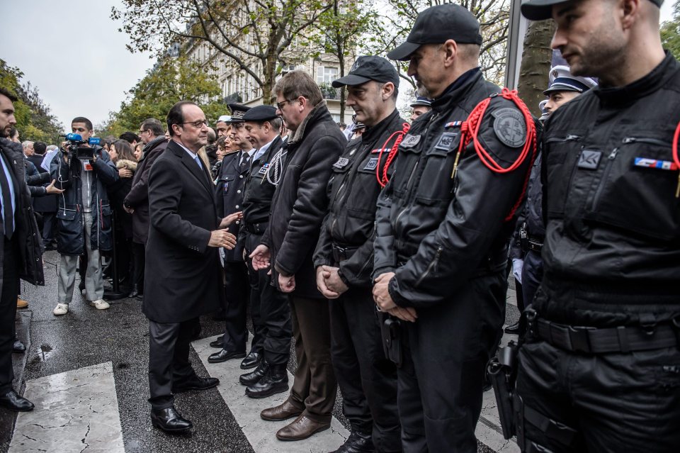 President Francois Hollande shakes hand with anti-terrorist police forces next to the Bataclan concert venue