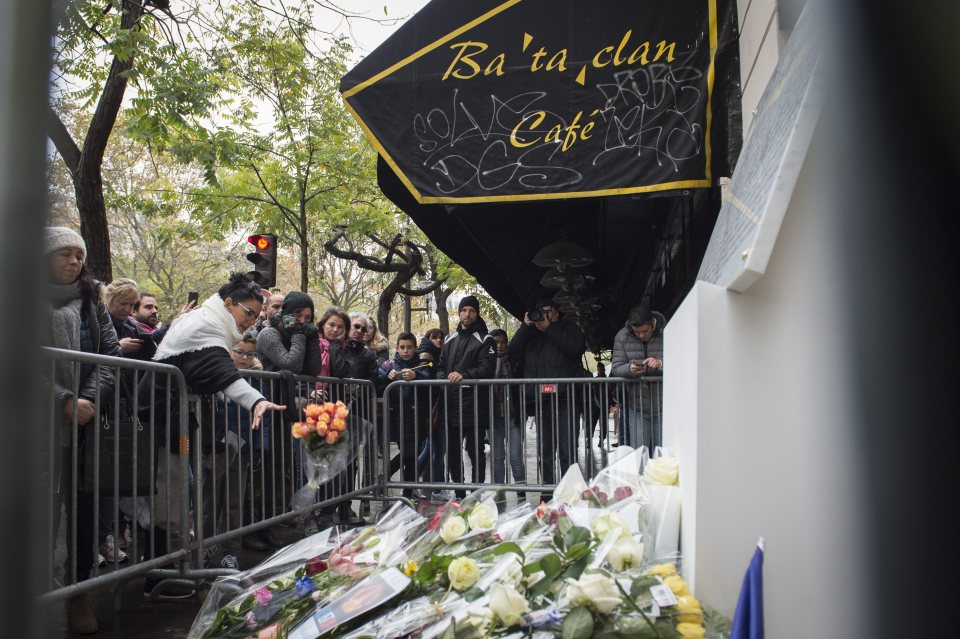 A woman pays her respects in front of the Bataclan concert venue to commemorate the one year anniversary of the Paris attacks