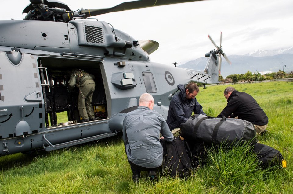 A Royal New Zealand Air Force NH90 helicopter delivers government officials and police to assess earthquake damage in Kaihoura