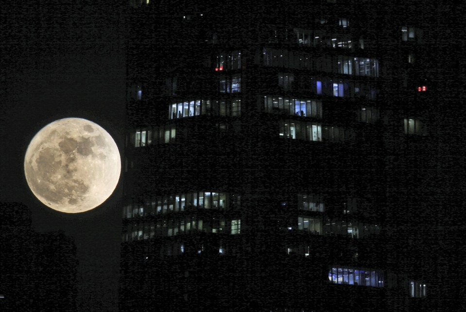 The supermoon rises over the city skyline in Dubai, United Arab Emirates