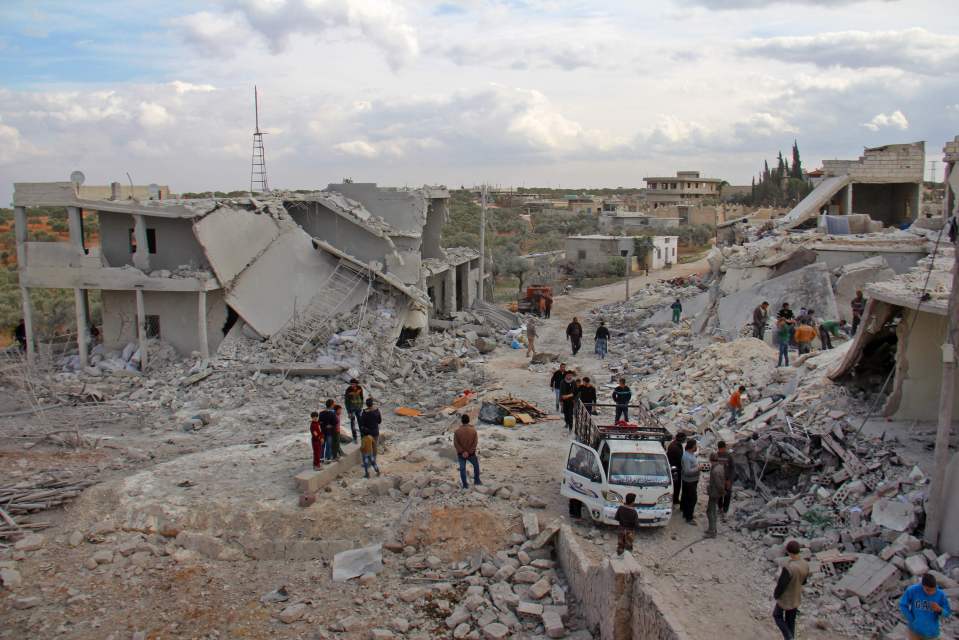 Civilians check destroyed buildings in t