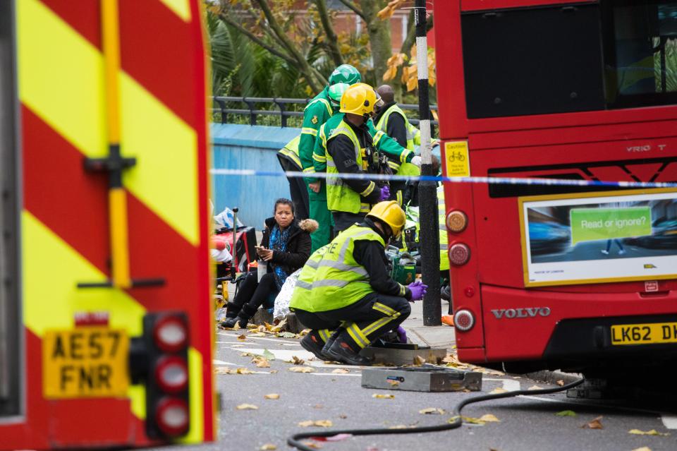 Fire crews and paramedics worked to free the trapped woman from beneath the bus 