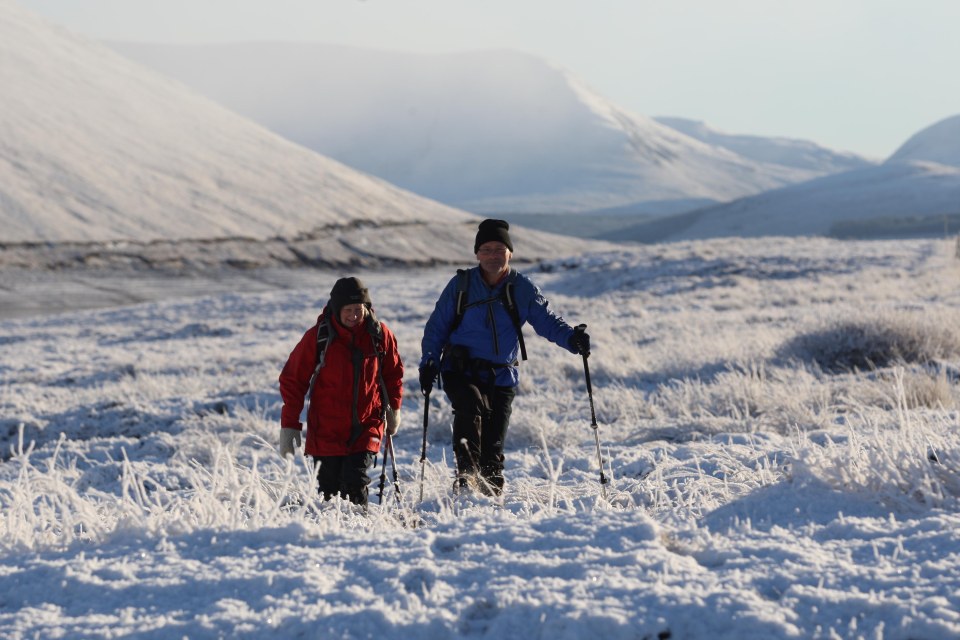 Hardy walkers trudge through the fresh snow at Loch Glascarnoch, where the temperature was -7C today