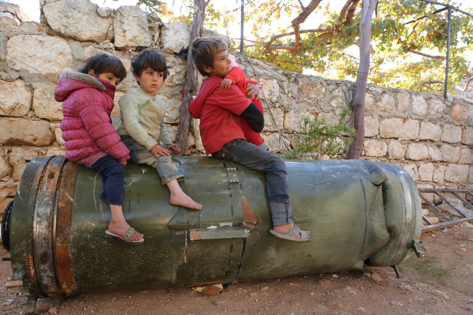 Children play on an unexploded Russian rocket, Anjara, Syria - 18 Nov 2016