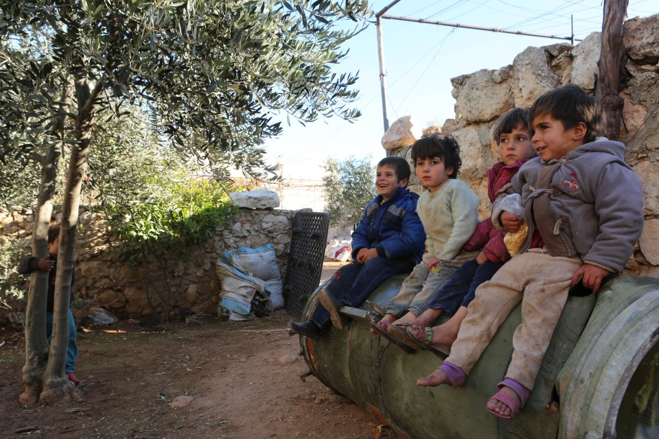 Children play on an unexploded Russian rocket, Anjara, Syria - 18 Nov 2016