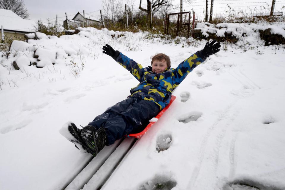 Wales, UK. 20th November, 2016. Aneurin Lewis aged 8 plays in the snow in the village of Trefil in South Wales. NOTE: Permission granted for photograph to be taken and used in the press by parents ¿ Steven Phillips/Alamy Live News