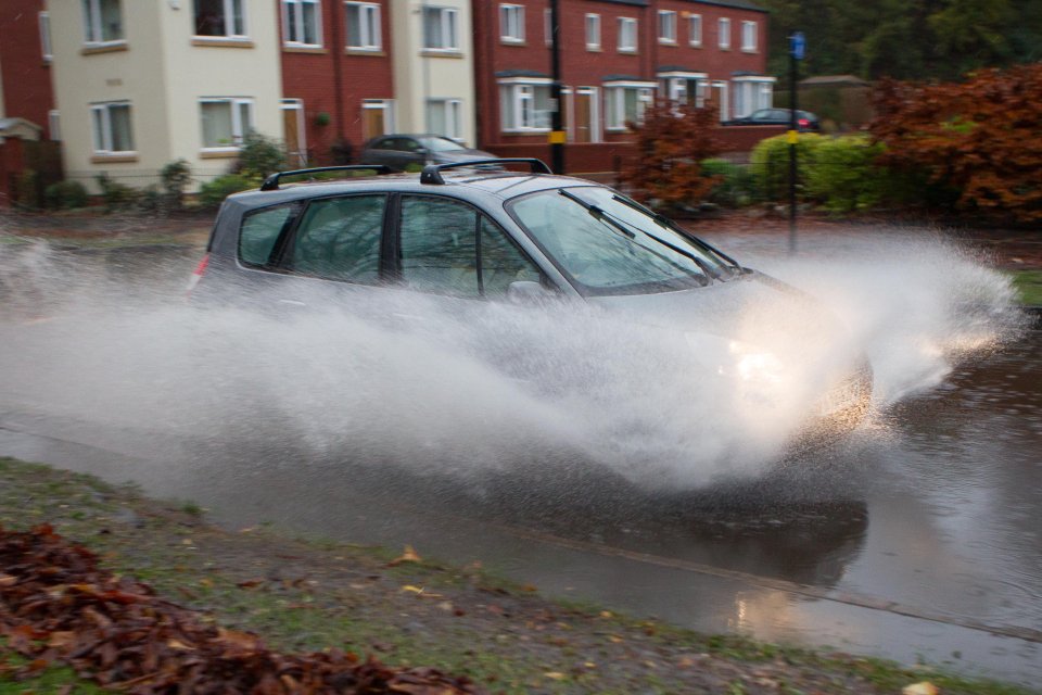 Cars driving through flooded Lickey Road in Birmingham