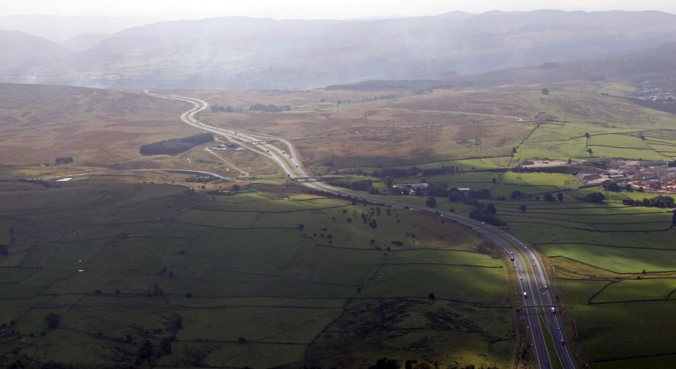 aerial view of the M6 motorway heading south through the Pennines towards Lancashire, UK