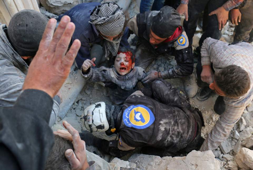 Shocking images showed a young Syrian boy being pulled from the rubble of a building in Aleppo