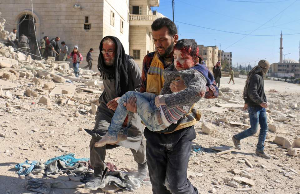 The dazed child was seen being carried away from the scene of the attack
