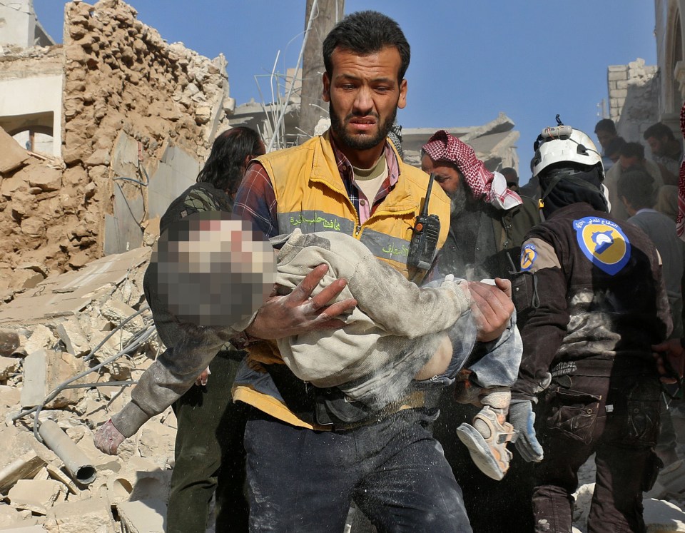 Harrowing images show another child being carried away from the bombing