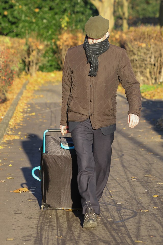 Simon Ball pictured trying to hide his face as he arrives at Peterborough Crown Court for sentencing