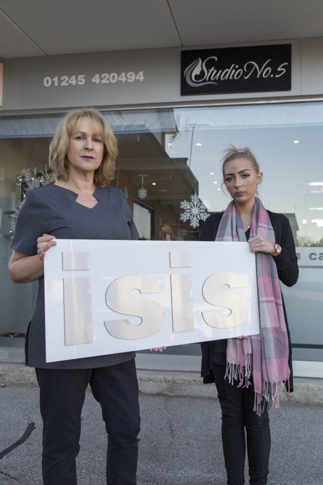 Owner Karen Lawrence and beauty therapist Lin Hoblin posing outside Studio No 5 with the old ISIS sign in Writtle, Essex