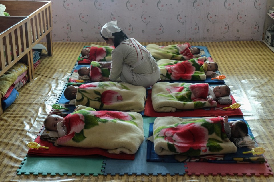 A nurse attends to young children in an orphanage near Nampo 