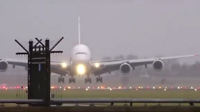 The plane rocks violently before safely landing on the runway 