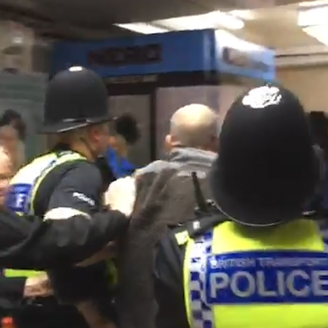 One man was led away by police after the confrontation