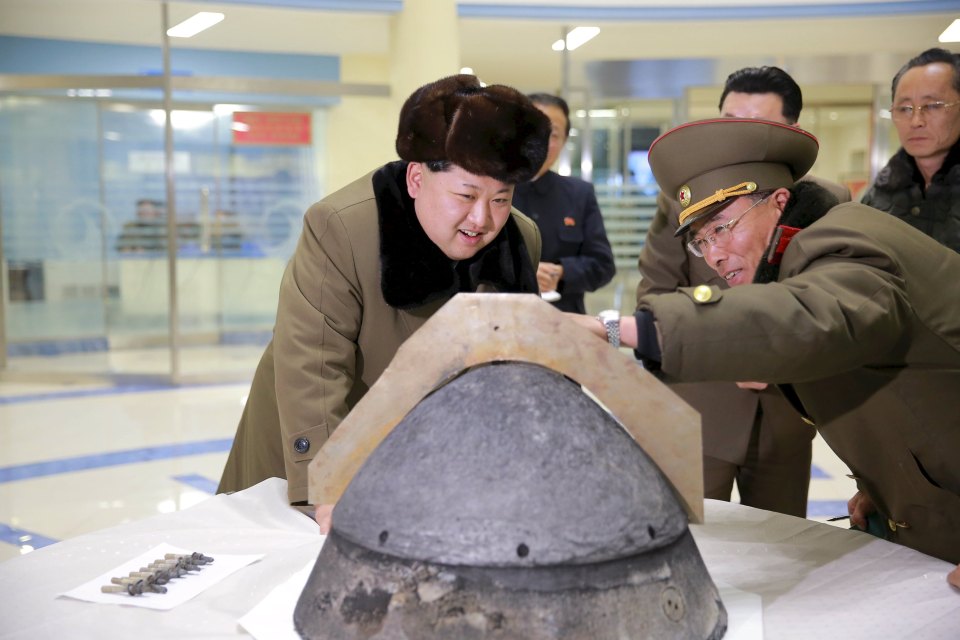 KCNA file picture shows North Korean leader Kim Jong Un looking at a rocket warhead tip after a simulated test of atmospheric re-entry of a ballistic missile