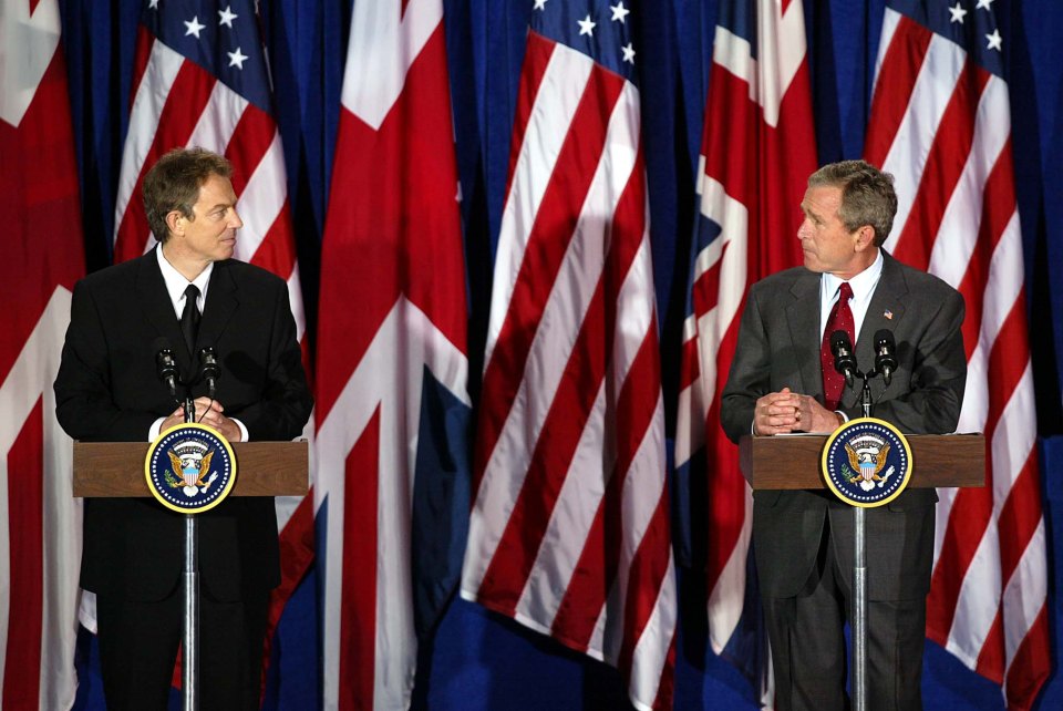 Tony Blair, left, and George Bush, right, speak together at a press conference