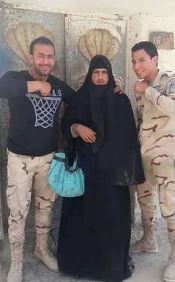 One black-clad jihadi accessorised with a green bag