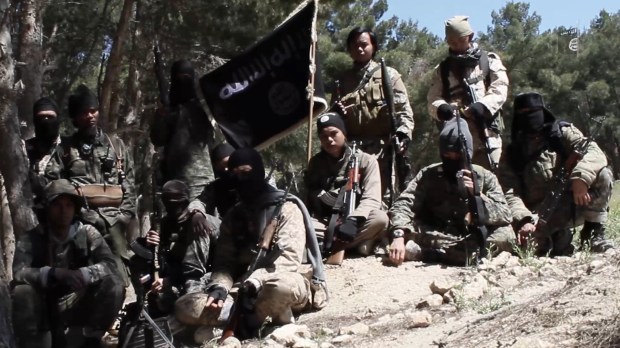 A still from a sick new ISIS video shows Donald Trump being bundled away by guards after assassination bid
