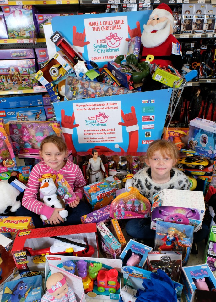 Sisters Delilah, 9, and Joanna, 10, from Southwark in south London help to spread some smiles by donating toys