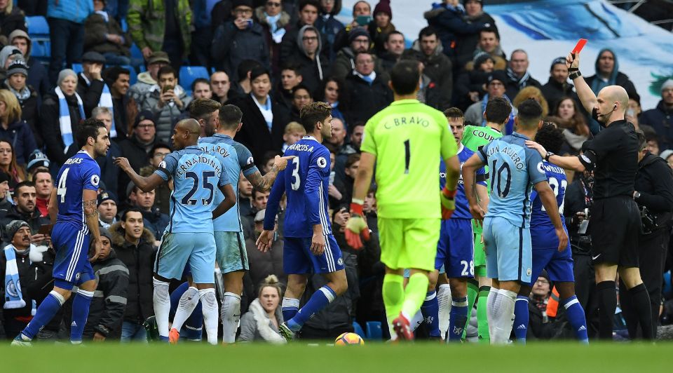 Manchester City's Brazilian midfielder Fernandinho (2L) remonstrates with Chelsea's Spanish midfielder Cesc Fabregas (L) as English referee Anthony Taylor (R) shows a red card to Manchester City's Argentinian striker Sergio Aguero (2r) for his challenge on Chelsea's Brazilian defender David Luiz during the English Premier League football match between Manchester City and Chelsea at the Etihad Stadium in Manchester, north west England, on December 3, 2016. / AFP PHOTO / Paul ELLIS / RESTRICTED TO EDITORIAL USE. No use with unauthorized audio, video, data, fixture lists, club/league logos or 'live' services. Online in-match use limited to 75 images, no video emulation. No use in betting, games or single club/league/player publications. / PAUL ELLIS/AFP/Getty Images