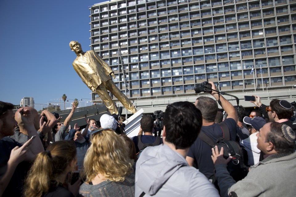 Bystanders gathered as the statue was pulled down. 