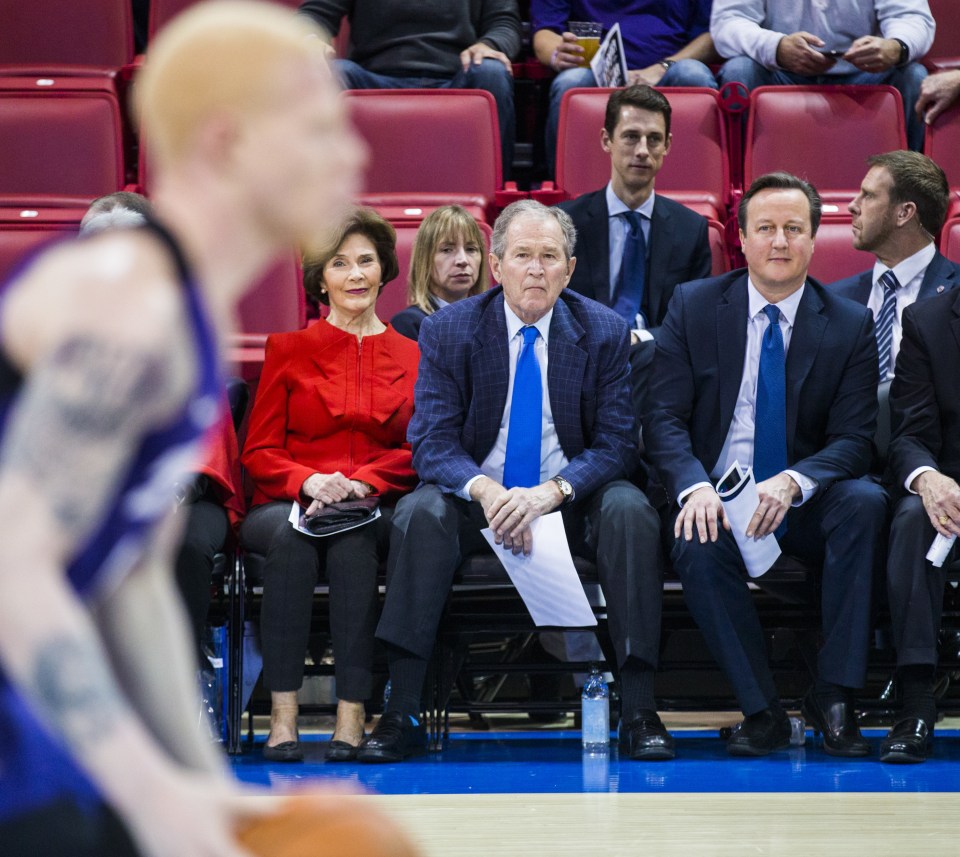 The pair, joined by former first lady Laura Bush, watch on as the athletes perform