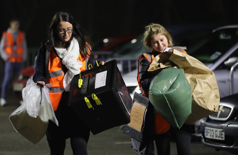 Ballot boxes arrive at the counting station after polls close