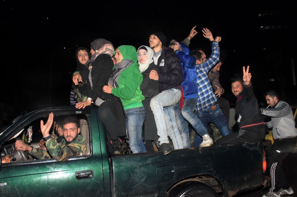 Syrians celebrate on December 12, 2016 i