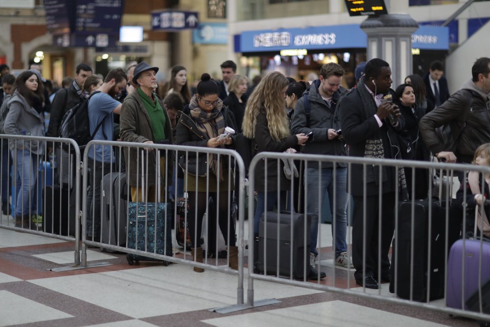  Passengers queue up for an express train to Gatwick Airport, running a reduced service as a result of a train strike