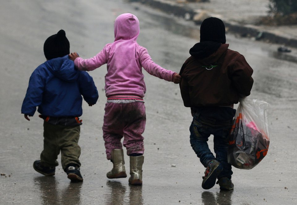 Children flee deeper into the remaining rebel-held areas of Aleppo