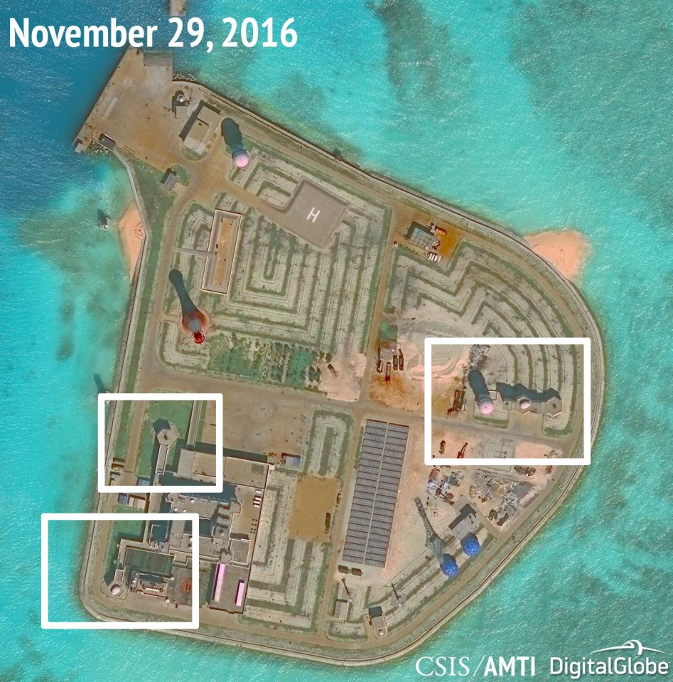 A satellite image shows what CSIS Asia Maritime Transparency Initiative says appears to be anti-aircraft guns and what are likely to be close-in weapons systems (CIWS) on the artificial island Johnson Reef in the South China Sea