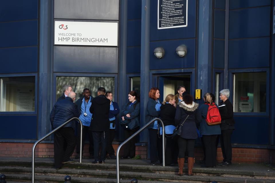 Staff outside the prison, who were evacuated to avoid a hostage situation
