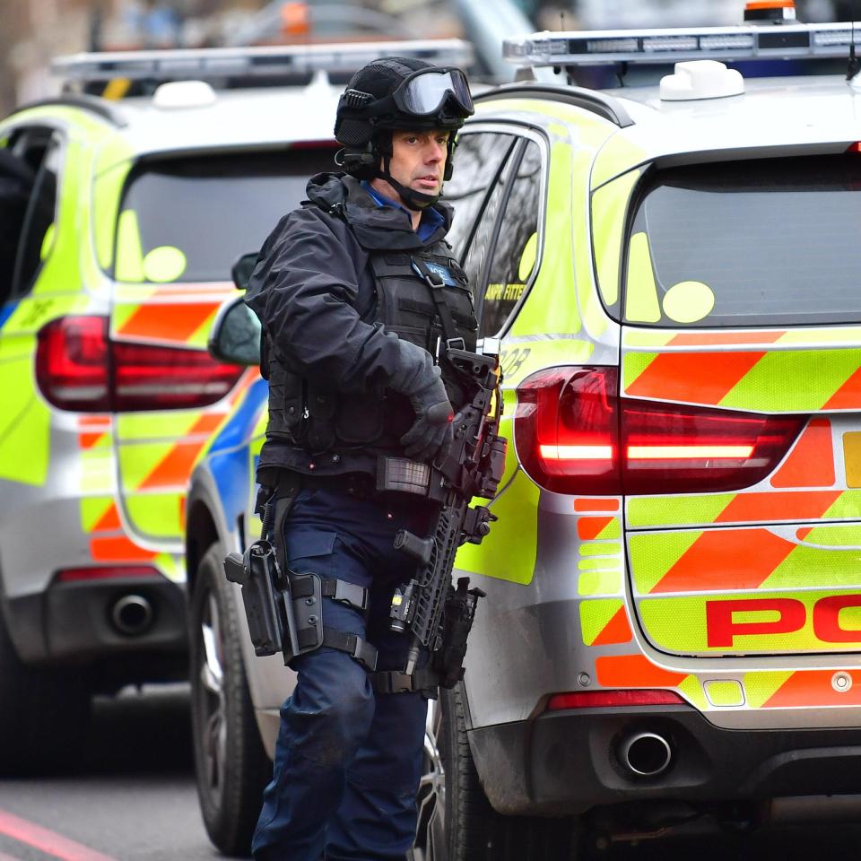 Cops shut down the street after receiving reports a man had a gun inside a house