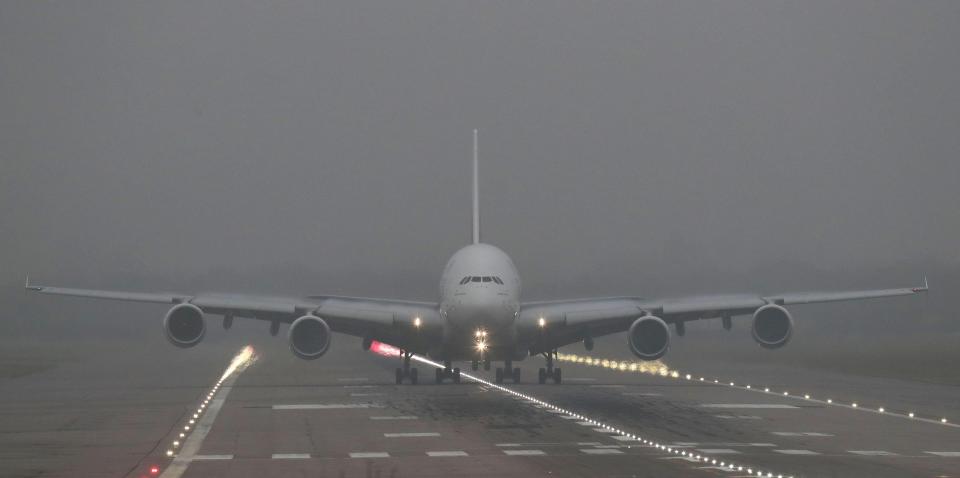 An Emirates Airbus A380 takes off from Gatwick Airport in west Sussex, as thick fog moving across the UK 