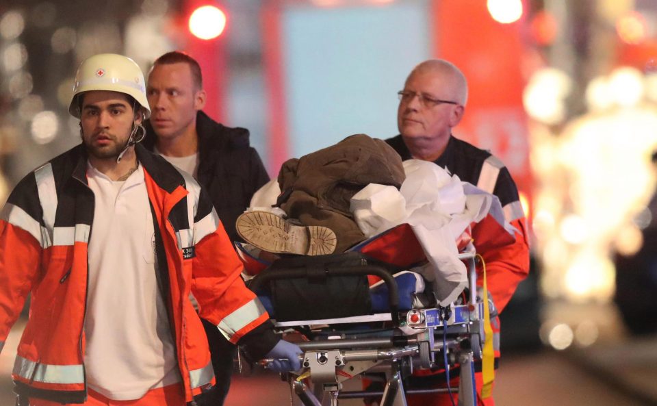  A rescue worker pushes a victim of the attack on a stretcher amid the carnage in Berlin