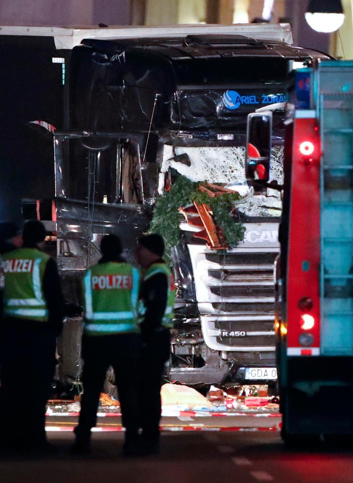  A smashed-up Christmas tree can be seen mangled on the truck's windscreen