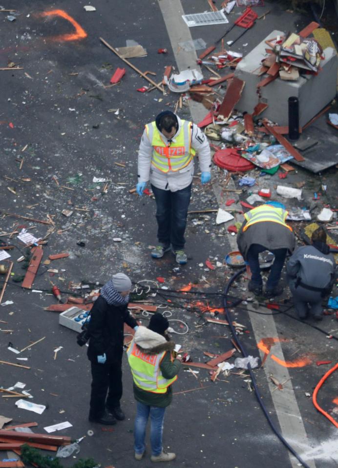  Forensic officers scoured the scene of the attack this afternoon as police admitted they may not have the right man