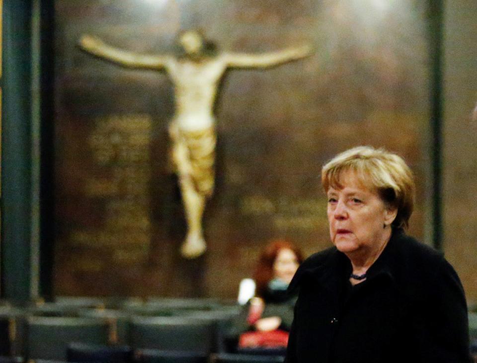 Angela Merkel appeared to weep for the victims today