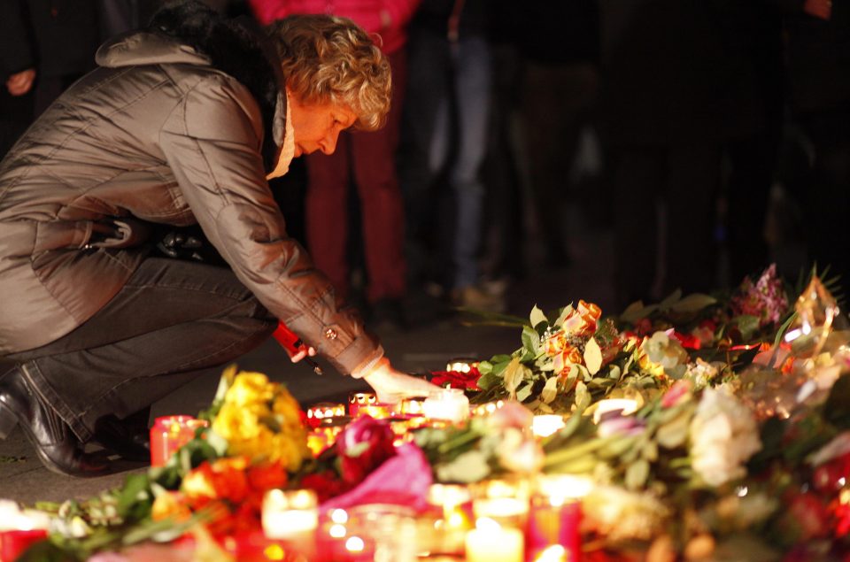  Berliners left flowers and candles at the scene of the attack as a makeshift shrine sprung up into the evening